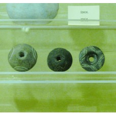 Pre-Christian crosses with holes engraved on stones